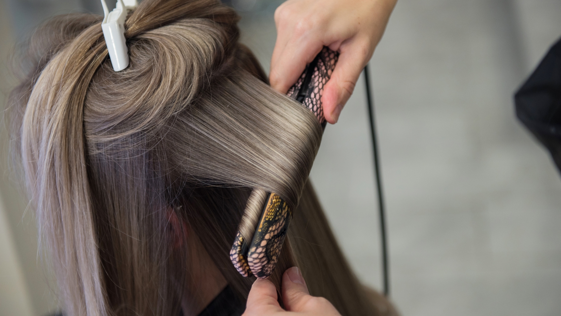 A woman getting her hair cut by a hair stylist