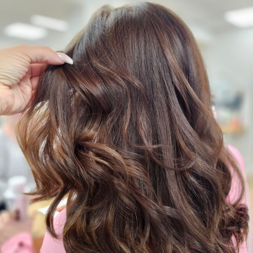 A woman is getting her hair done in a salon